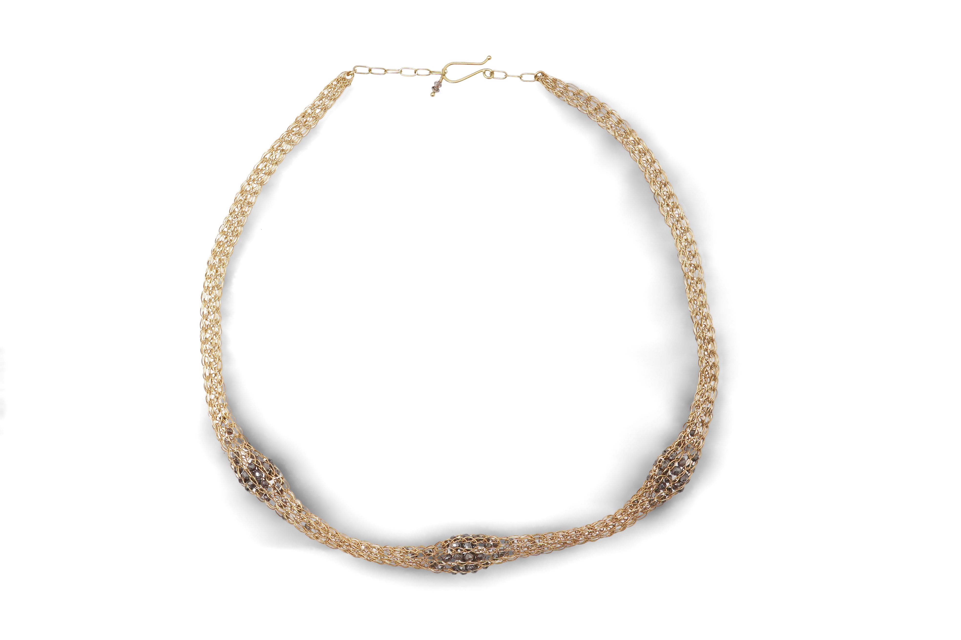 An 18ct gold and diamond necklace, composed of a woven tube of 18ct gold wire links, three sections threaded with brown diamond beads, length approximately 45cm, British hallmarks, sponsor's mark TJH, gross weight approx